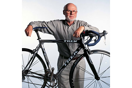 A man holding a bicycle.